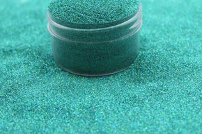 A teal holographic glitter in an ultra fine cut
